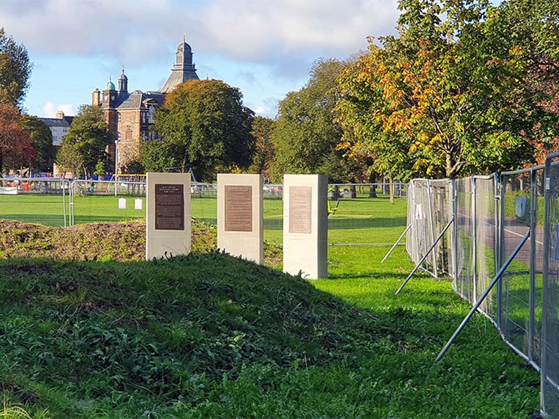 A general view showing the three plaques beside the statue